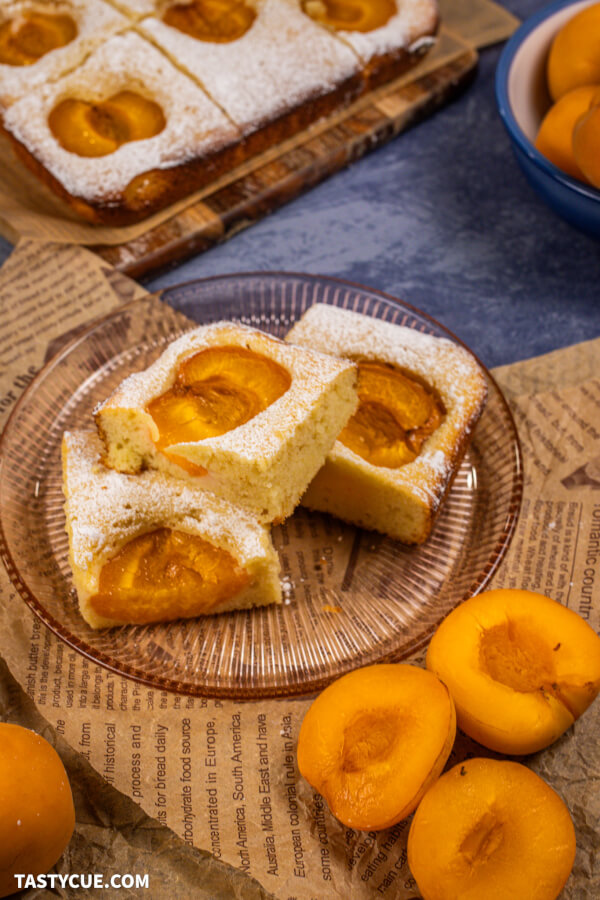 traditional austrian apricot cake (Marillenkuchen vom Blech) on a vintage plate, with newspaper 